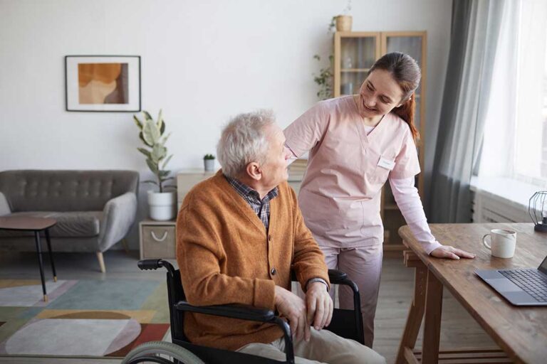 A senior couple reviews documents with a notepad and calculator in a cozy living room.